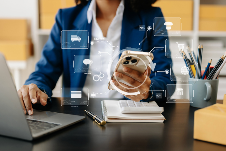 Female business worker holding smart phone with app icon graphics